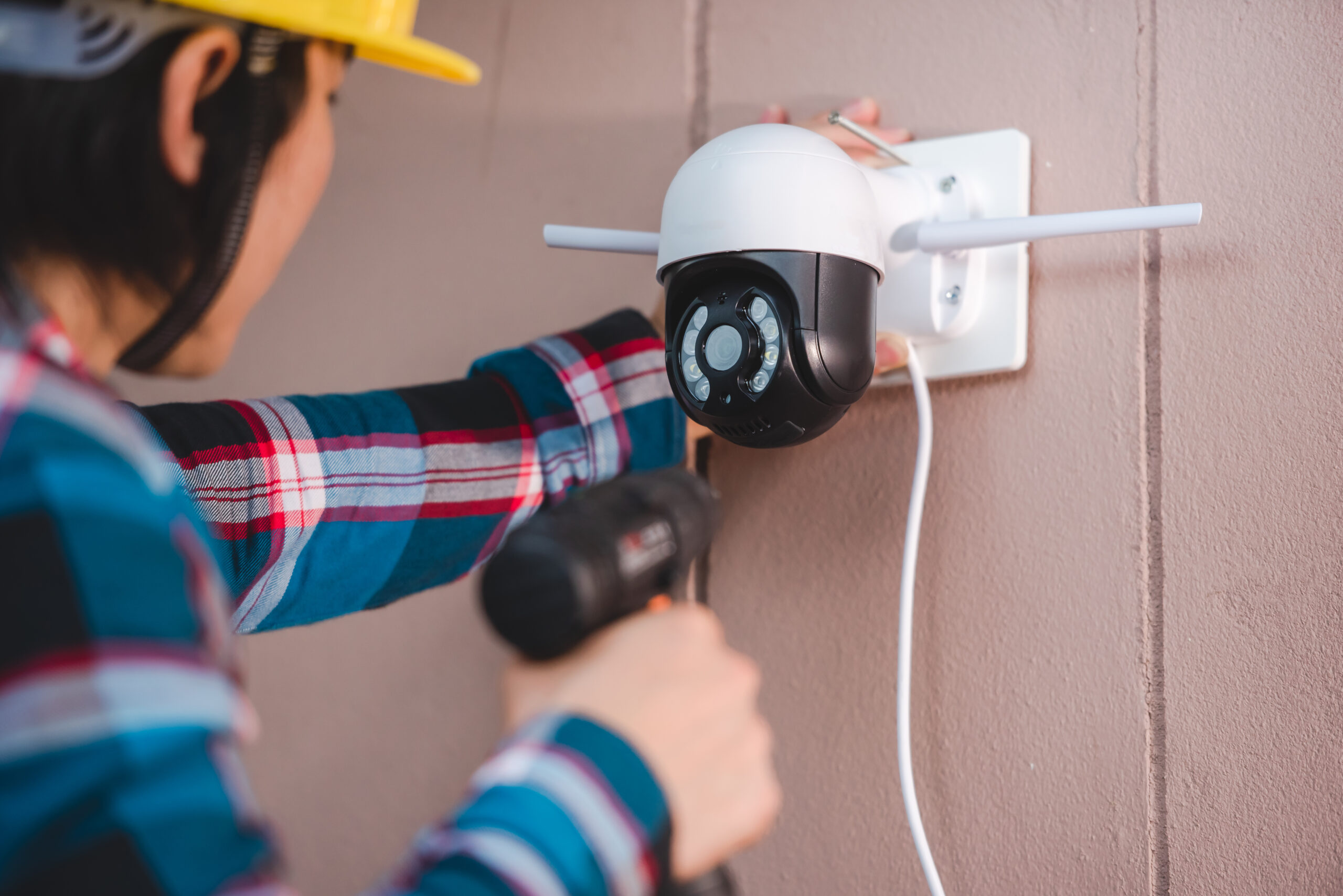 Professional CCTV installer fitting a security camera
